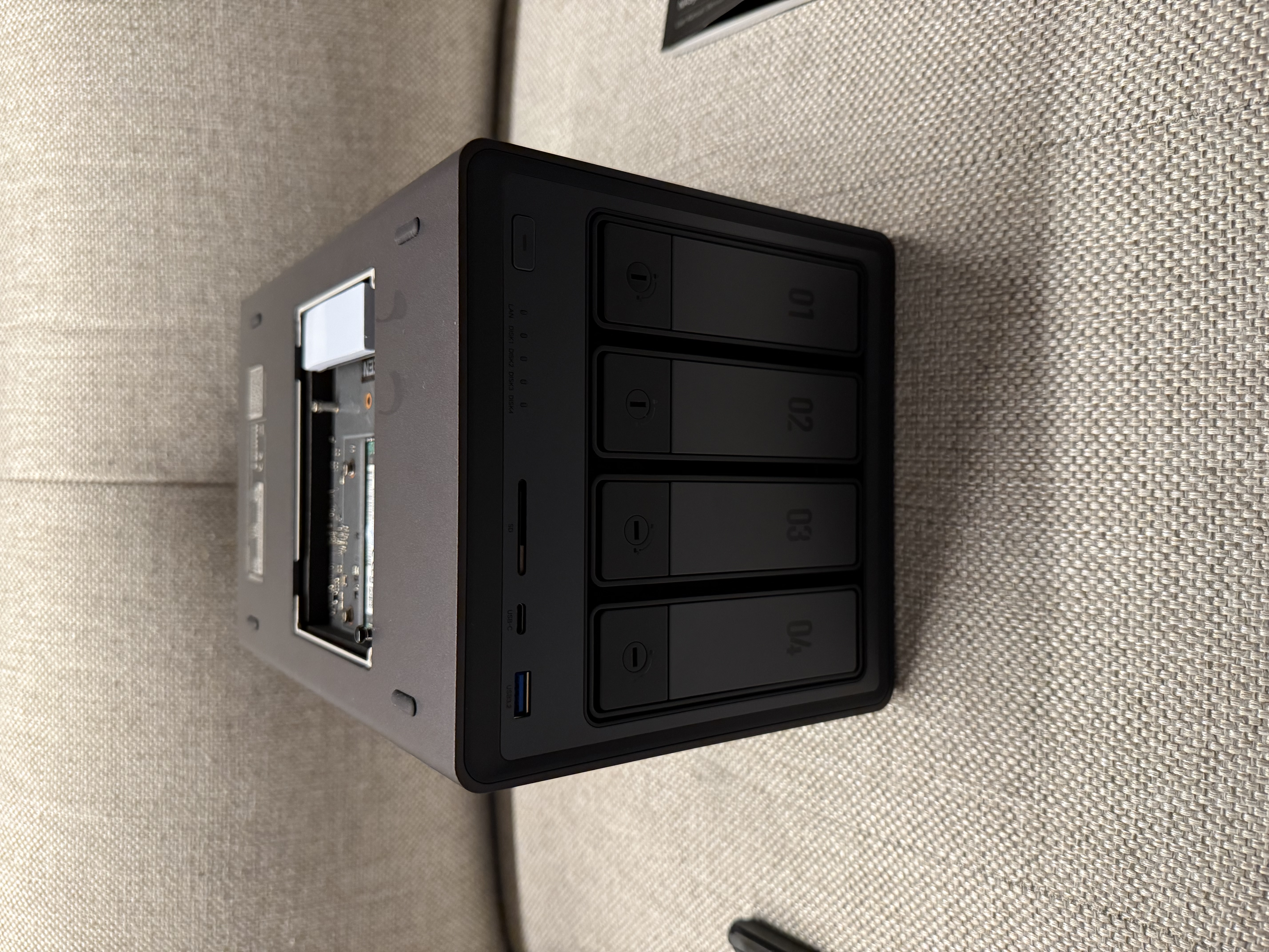 UGREEN DXP4800 NAS with the top panel open, showing the M.2 SSD and RAM slots